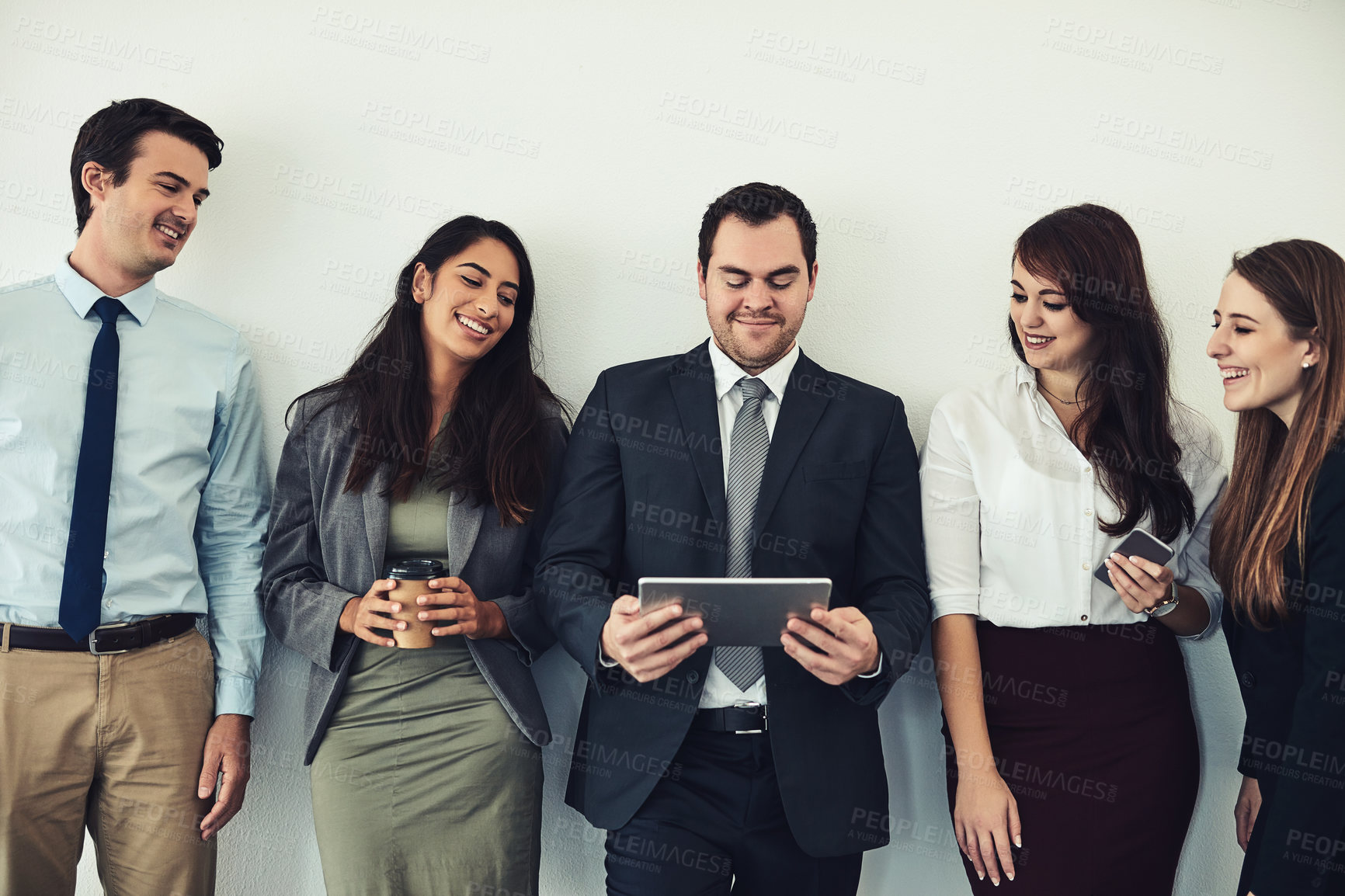 Buy stock photo Studio shot of a group of businesspeople using wireless technology while standing in line