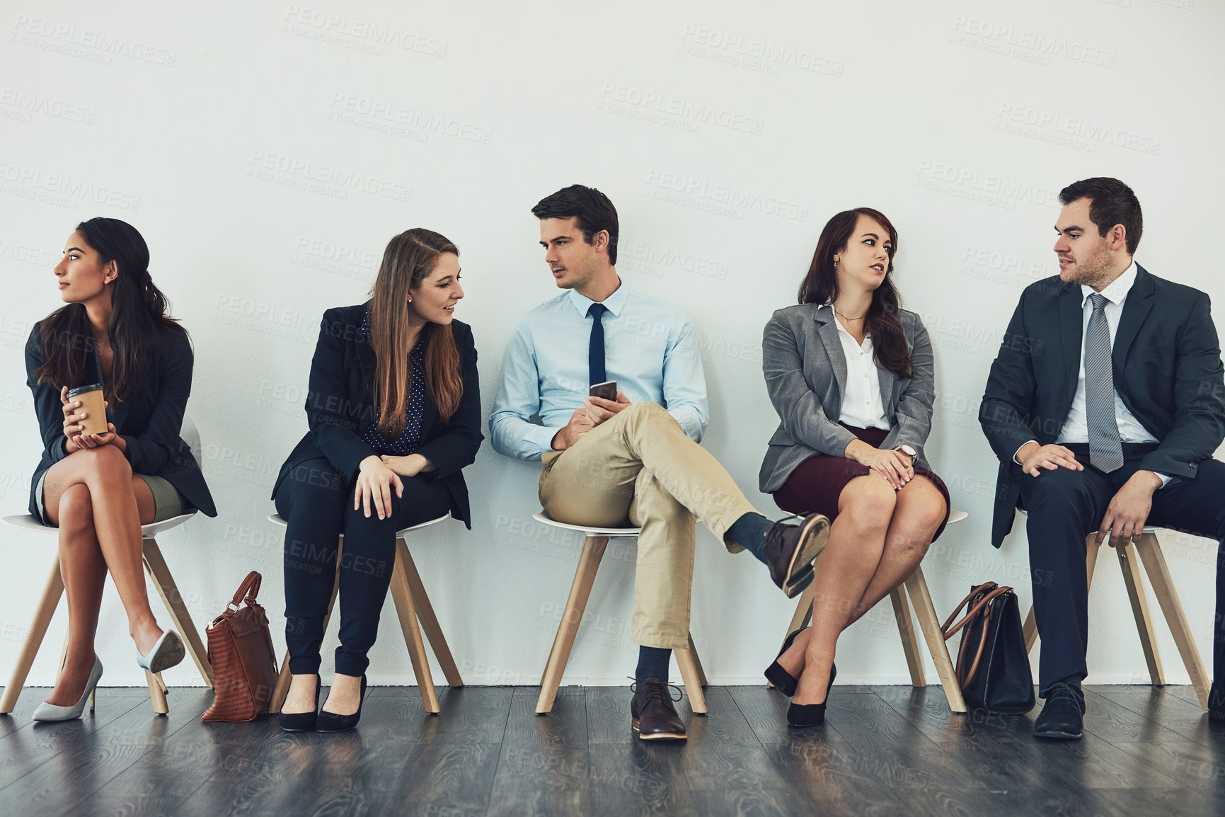 Buy stock photo Studio shot of a group of businesspeople talking while waiting in line