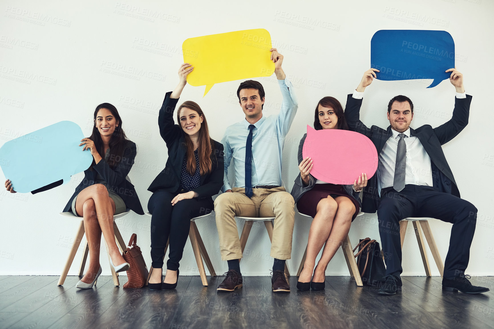 Buy stock photo Studio shot of a group of businesspeople holding colorful speech bubbles while waiting in line