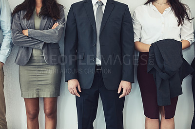 Buy stock photo Cropped studio shot of a group of young businesspeople standing together in a row