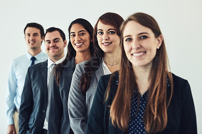 Buy stock photo Studio shot of a group of confident young businesspeople standing together in a row