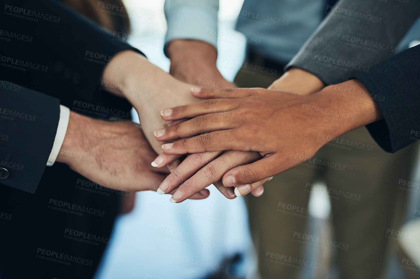 Buy stock photo Cropped shot of a group of businesspeople joining their hands in solidarity