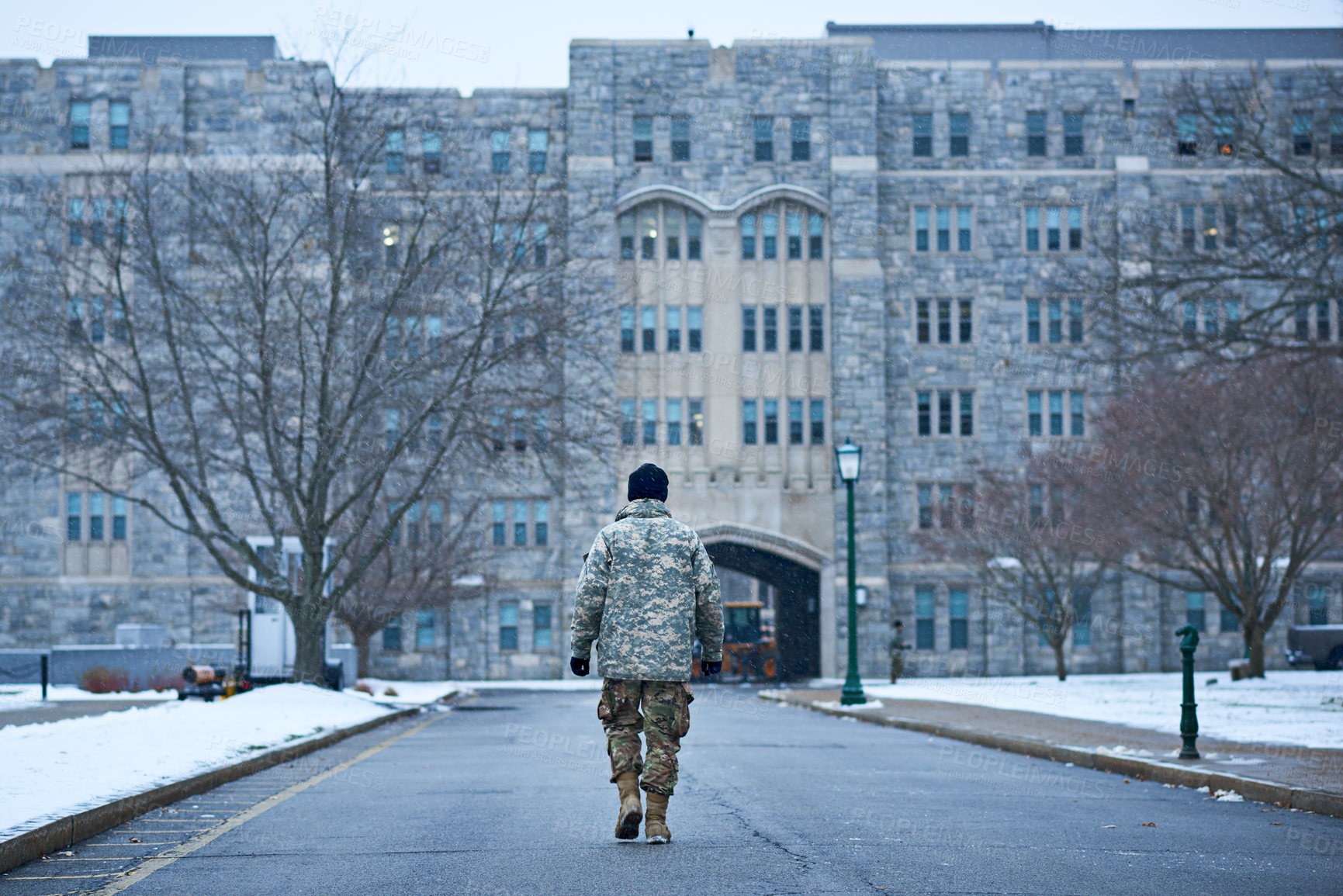 Buy stock photo Rearview shot of a young soldier walking to the entrance of an academy