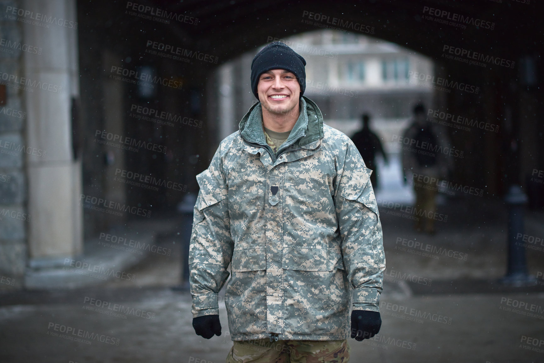 Buy stock photo Shot of a young soldier standing outside on a cold day at military school