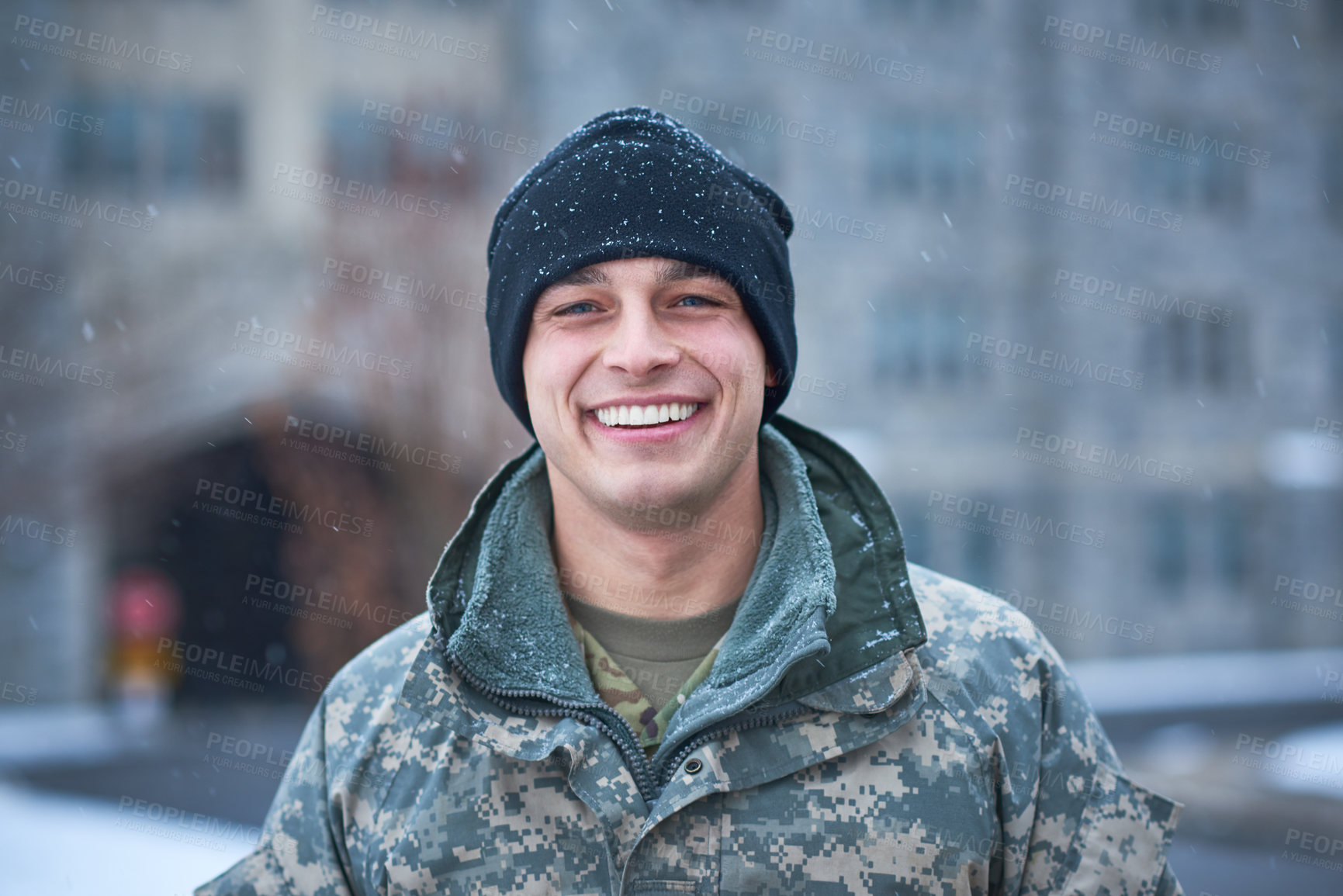 Buy stock photo Shot of a young soldier standing outside on a snowy day at military school