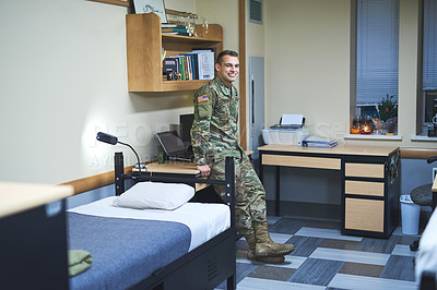 Buy stock photo Shot of a young soldier in the dorms of a military academy