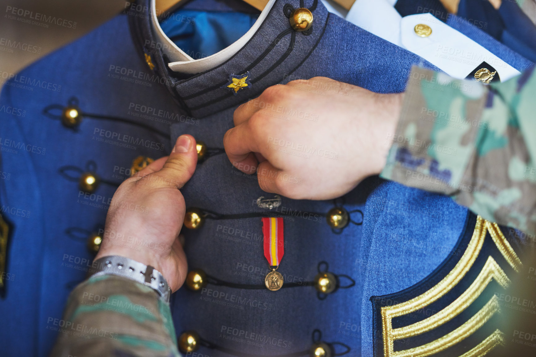Buy stock photo Cropped shot of a soldier pinning a medal to his jacket