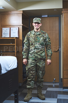 Buy stock photo Shot of a young soldier standing in the dorms of a military academy