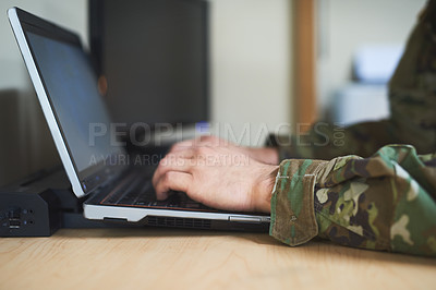 Buy stock photo Cropped shot of a soldier using a laptop in the dorms of a military academy