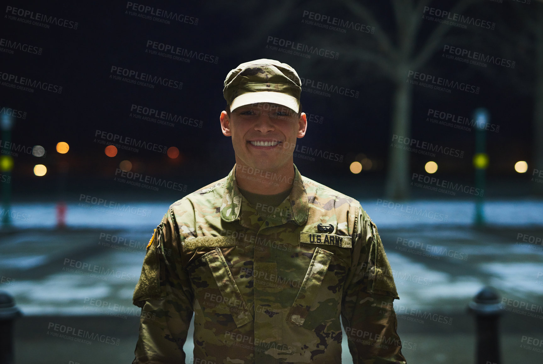 Buy stock photo Shot of a young soldier standing outside on a cold night at a military academy