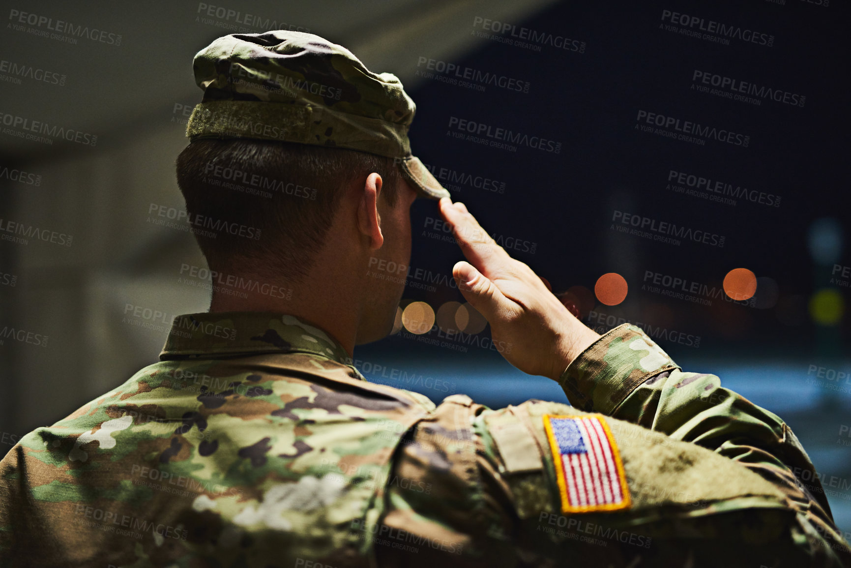 Buy stock photo Rearview shot of a young soldier standing at a military academy and saluting