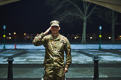 Buy stock photo Shot of a young soldier standing at a military academy and saluting