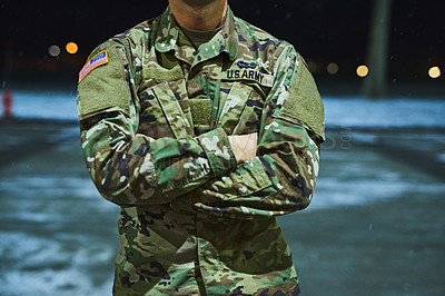 Buy stock photo Cropped shot of a soldier standing outside on a cold night at a military academy