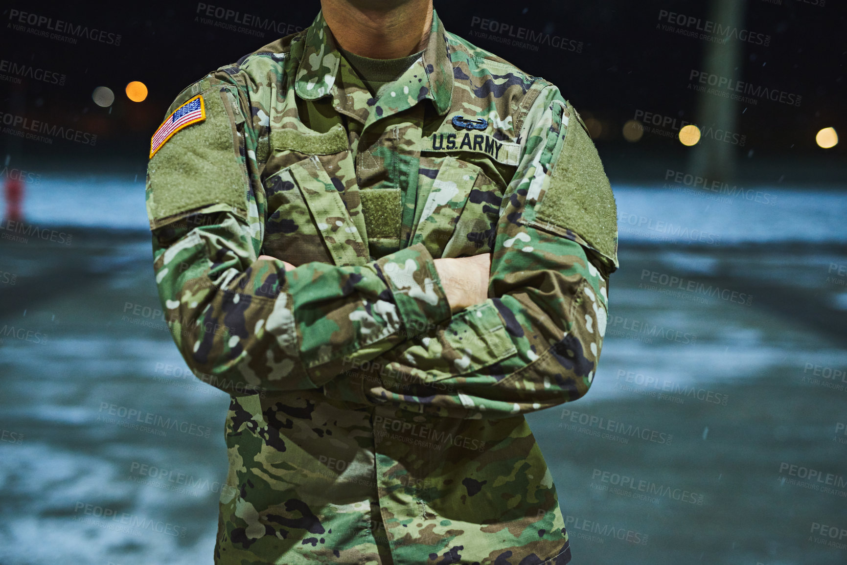 Buy stock photo Cropped shot of a soldier standing outside on a cold night at a military academy