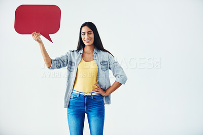 Buy stock photo Studio shot of an attractive young woman holding a speech bubble