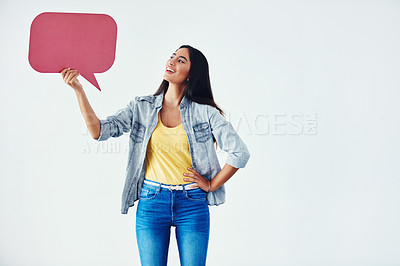 Buy stock photo Studio shot of an attractive young woman holding a speech bubble