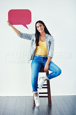 Buy stock photo Studio shot of an attractive young woman holding a speech bubble