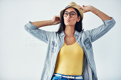 Buy stock photo Studio shot of a beautiful young woman wearing a hat against a white background