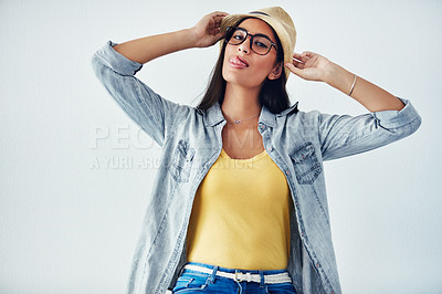 Buy stock photo Studio shot of a beautiful young woman wearing a hat against a white background