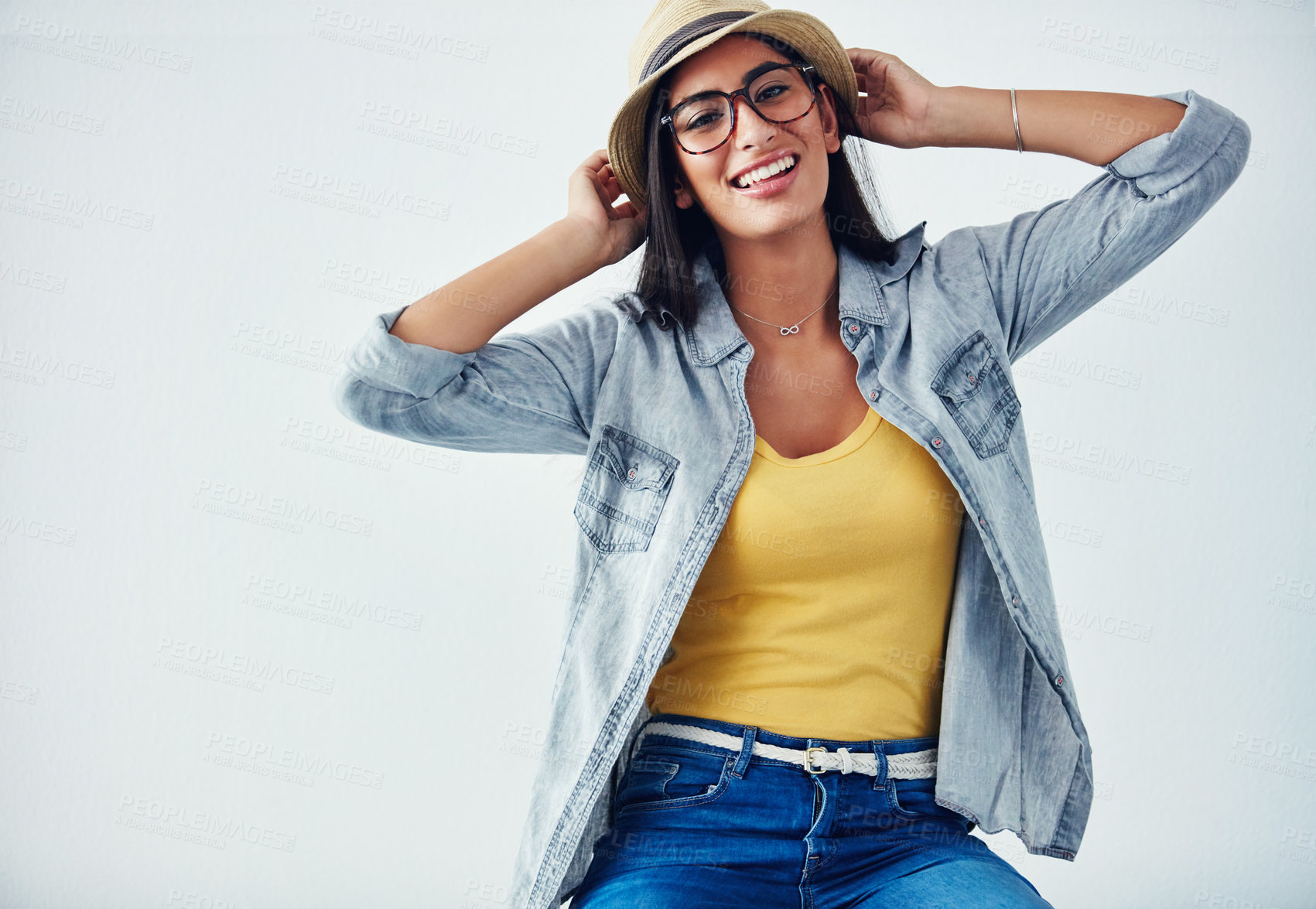 Buy stock photo Studio shot of a beautiful young woman wearing a hat against a white background