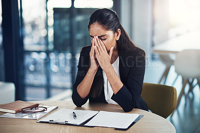 Buy stock photo Shot of a young businesswoman looking stressed out in an office