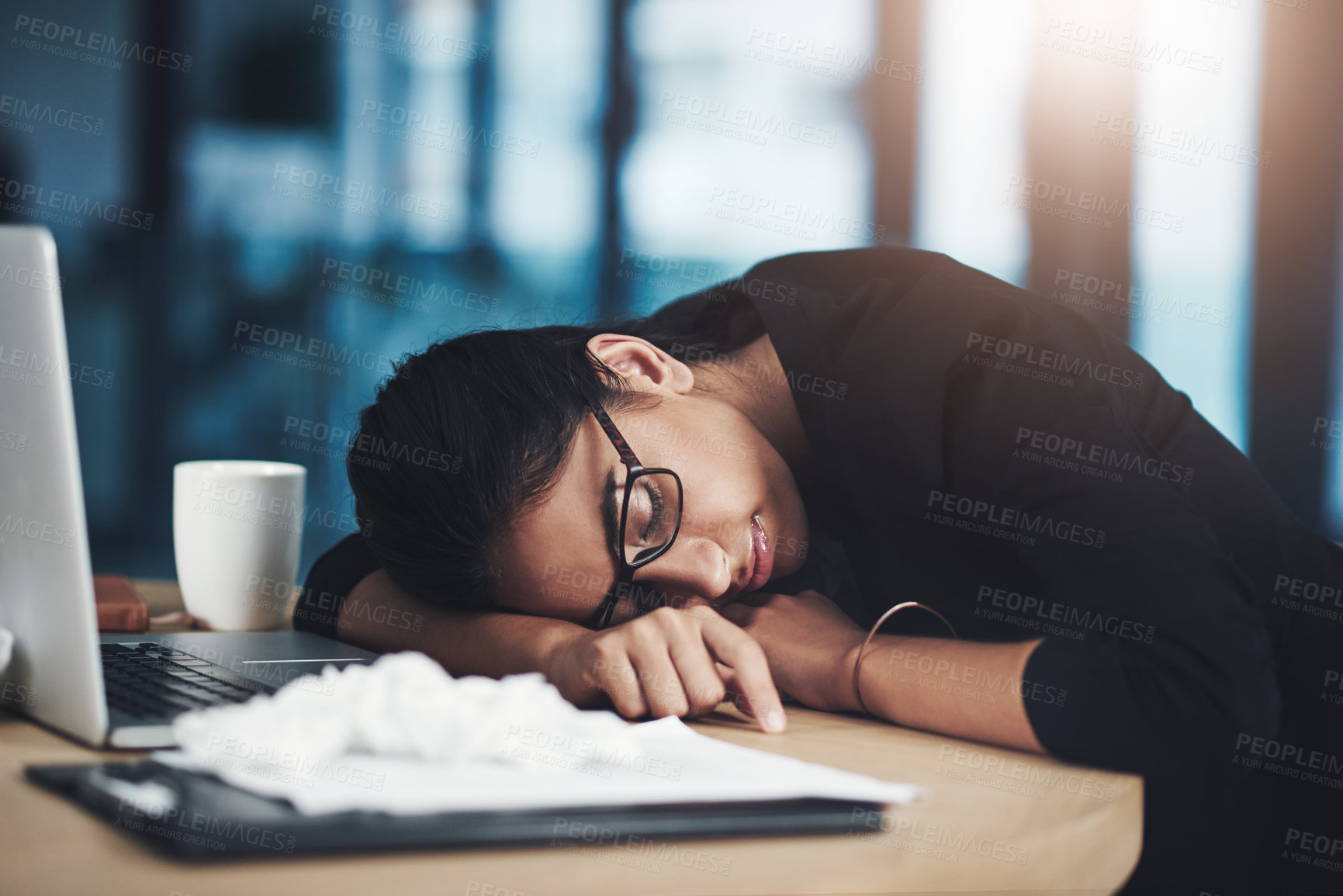 Buy stock photo Shot of a young businesswoman sleeping at her desk while working in an office