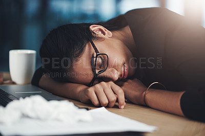 Buy stock photo Shot of a young businesswoman sleeping at her desk while working in an office