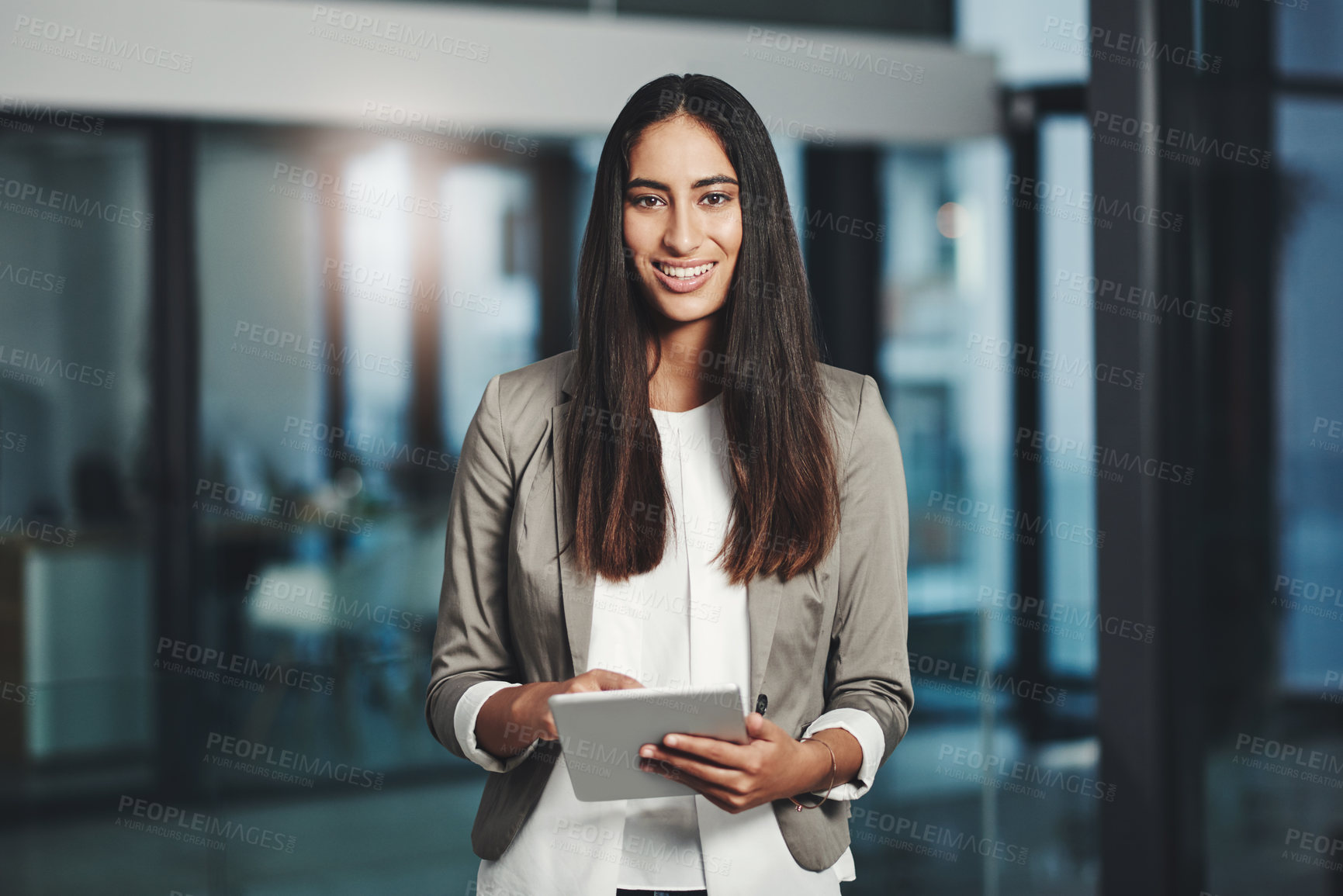 Buy stock photo Portrait of a young businesswoman working on a digital tablet in an office