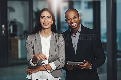 Buy stock photo Portrait of two young businesspeople standing together in an office