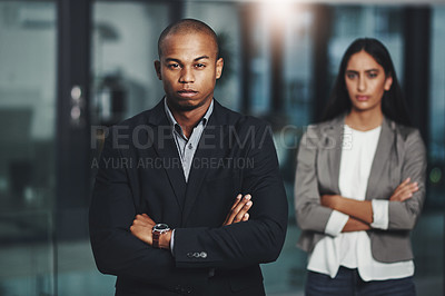 Buy stock photo Portrait of a young businessman standing in an office with his colleague in  the background