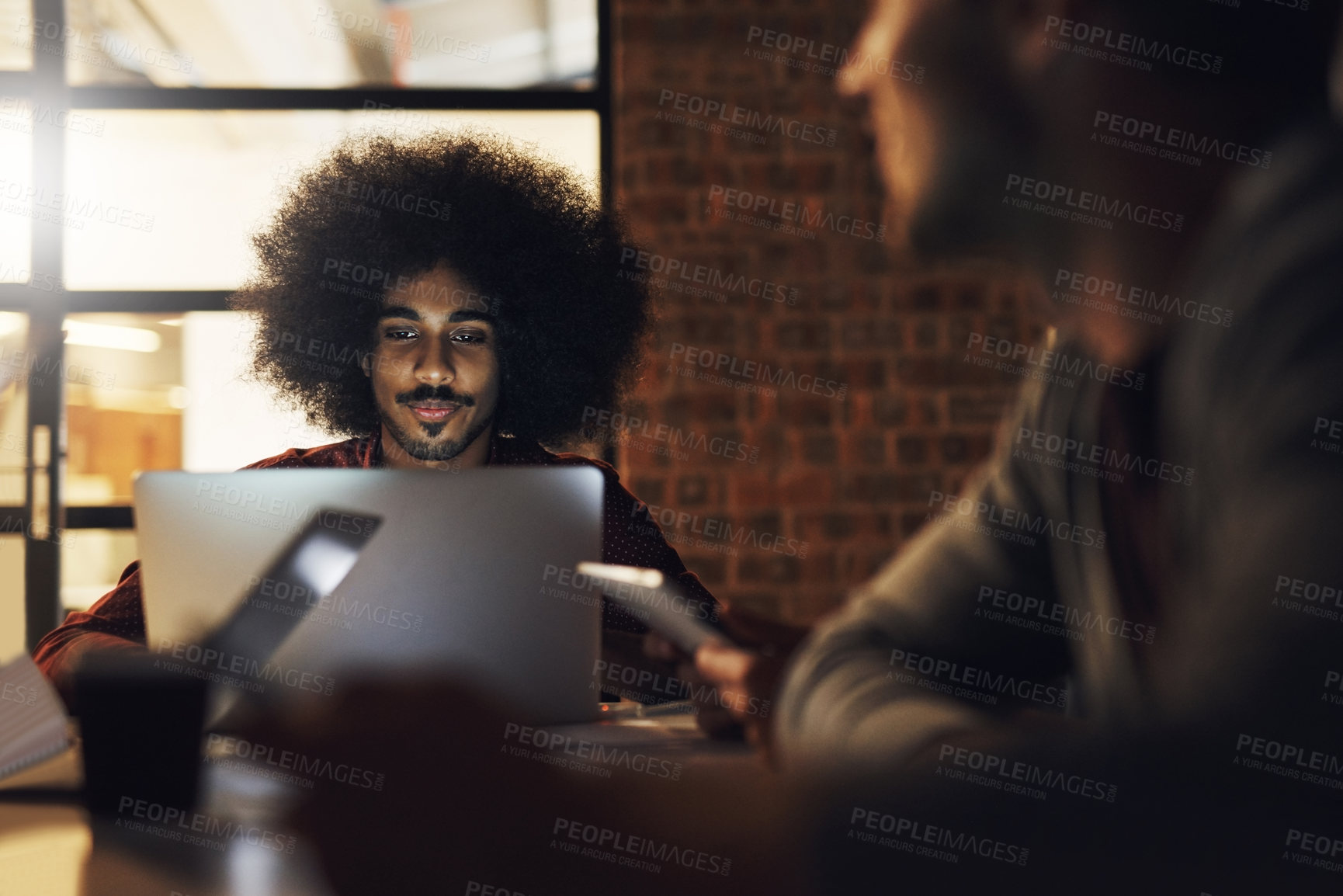 Buy stock photo Cropped shot of a handsome young male designer sitting in the boardroom during a meeting
