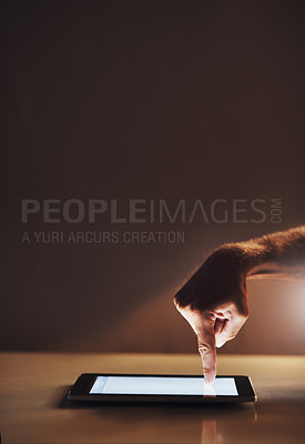 Buy stock photo Cropped shot of an unrecognizable male designer working on a digital tablet in his office