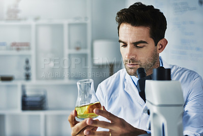 Buy stock photo Shot of a scientist conducting an experiment in a lab