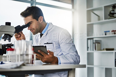 Buy stock photo Shot of a scientist using a microscope and digital tablet while working in a lab