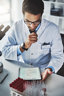 Buy stock photo Shot of a scientist using a digital tablet while working in a lab