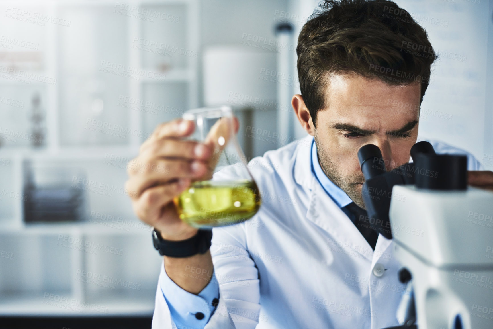 Buy stock photo Man, microscope and scientist with liquid in laboratory for clinical analysis, medical experiment and scientific study. Male doctor, fluid and sample for chemical reaction, development and innovation