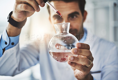 Buy stock photo Shot of a scientist conducting an experiment in a lab