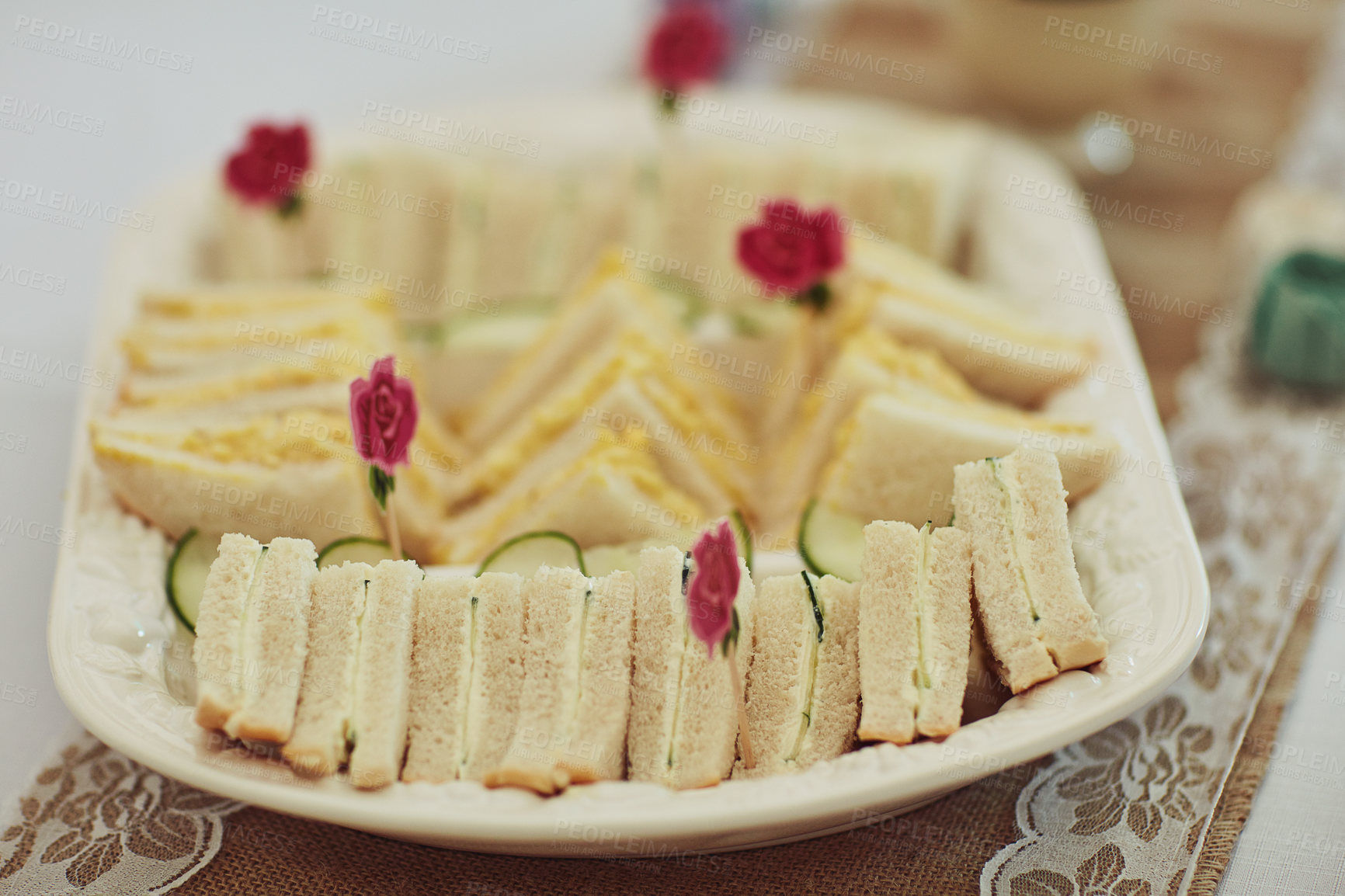 Buy stock photo Food, catering or sandwiches on table at event, tea party or thanksgiving celebration at home. Elegant snacks, buffet and bread closeup at gathering with red rose for floral decoration or hospitality