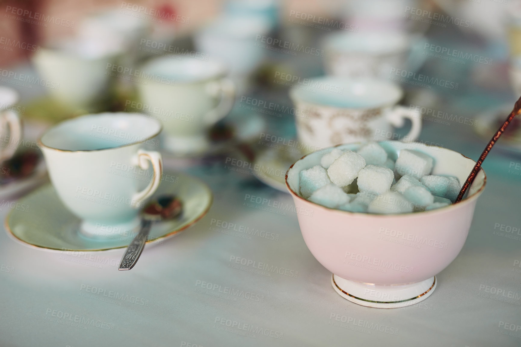 Buy stock photo Closeup shot of tea cups laid out on a table at a tea party inside