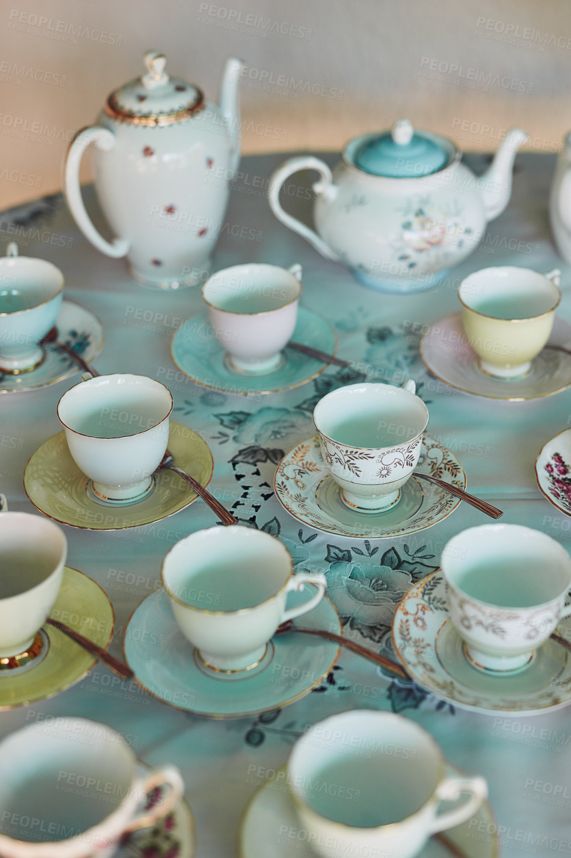 Buy stock photo Shot of tea pots and tea cups laid out on a table at a tea party inside