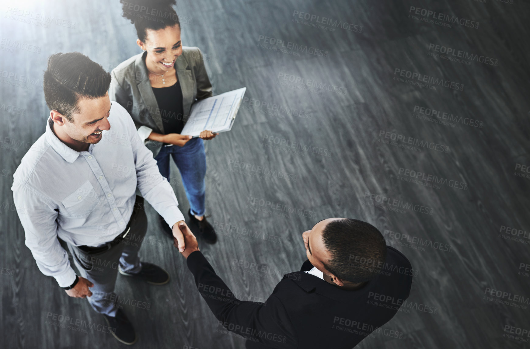 Buy stock photo High angle shot of two businesspeople shaking hands in an office