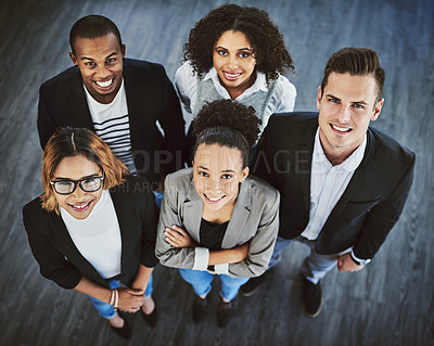 Buy stock photo High angle shot of a group of businesspeople standing together in an office