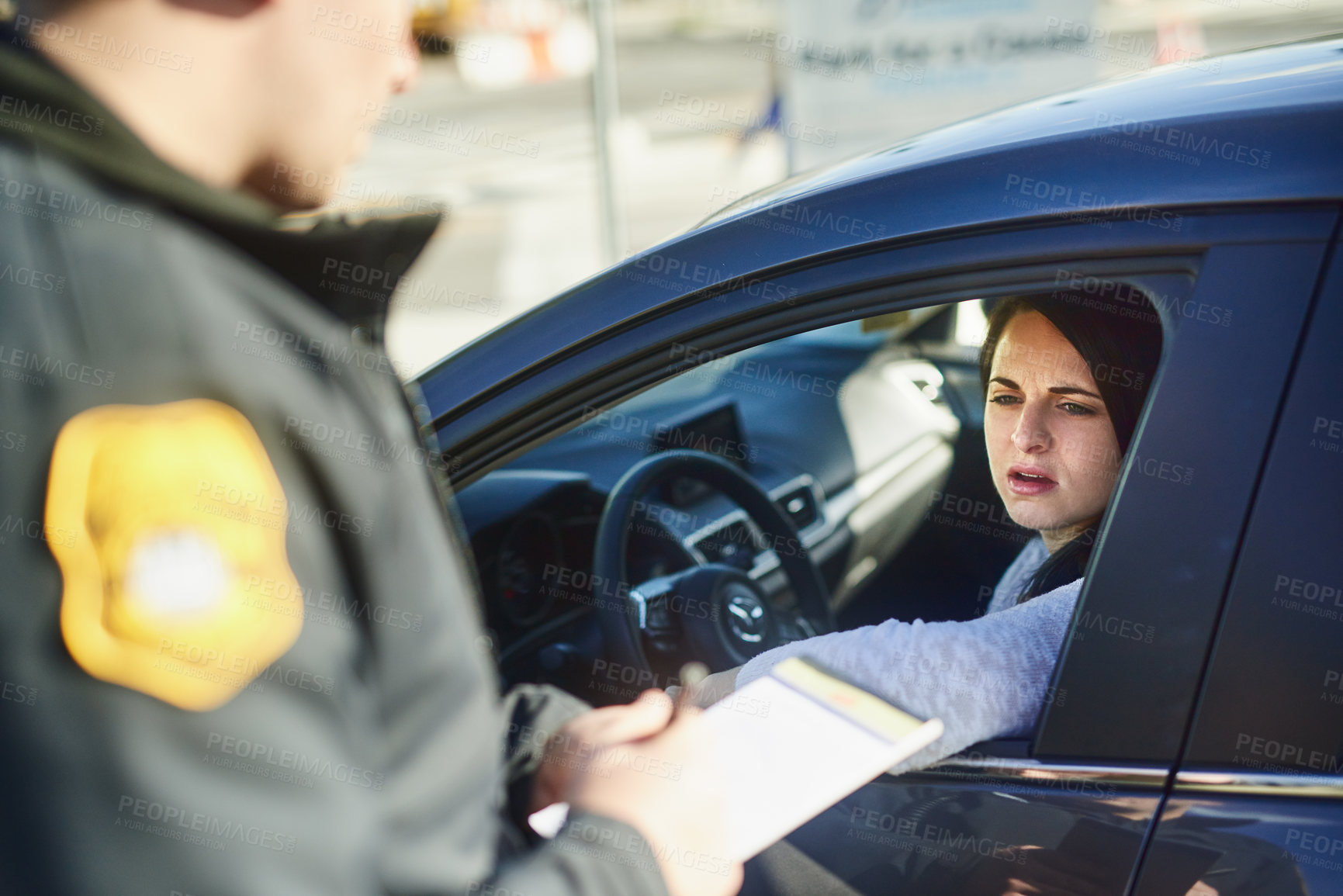 Buy stock photo Cropped shot of an unrecognizable male traffic officer issuing a ticket to a female civilian at a roadblock