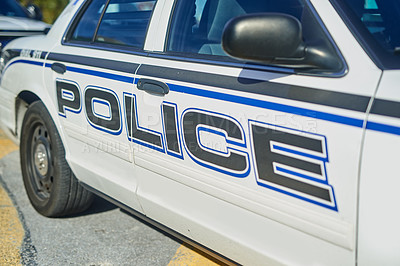 Buy stock photo Cropped shot of the side of a police squad car outside