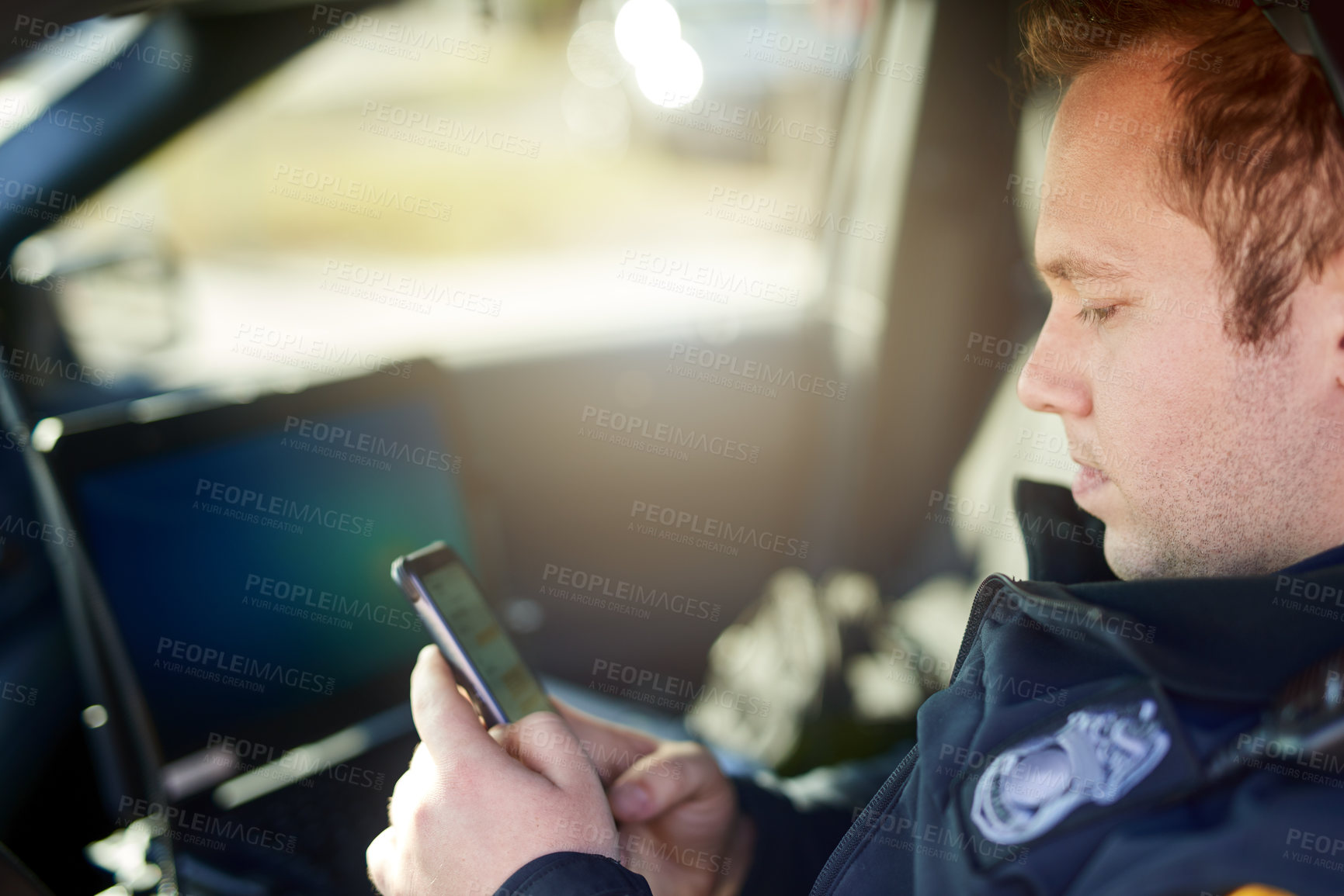 Buy stock photo Police, officer and man texting with phone in patrol car for security contact, law enforcement update and mobile notification. Policeman typing message on cellphone for crime news, connection and app