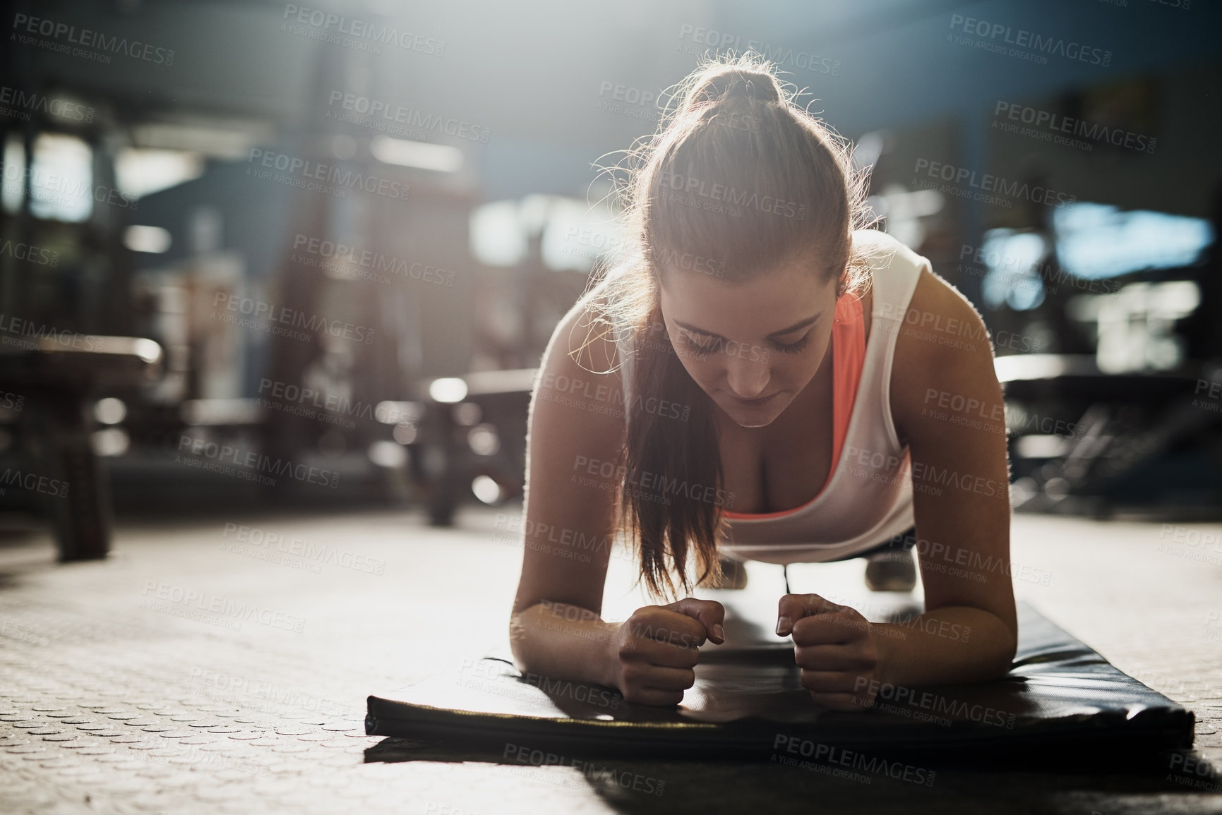 Buy stock photo Shot of a young woman working out at the gym