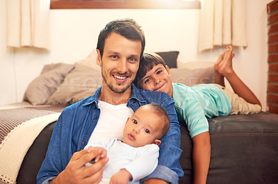 Buy stock photo Cropped portrait of a handsome young dad and his two sons spending quality time together at home