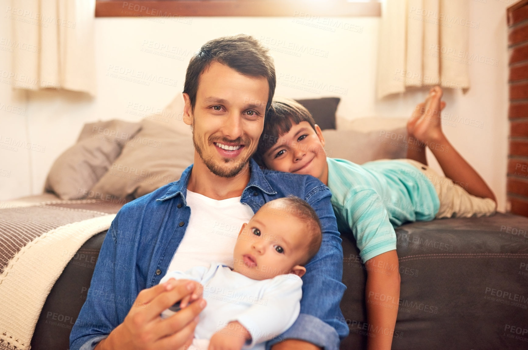 Buy stock photo Cropped portrait of a handsome young dad and his two sons spending quality time together at home