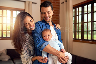 Buy stock photo Cropped shot of an affectionate young couple and their baby boy at home