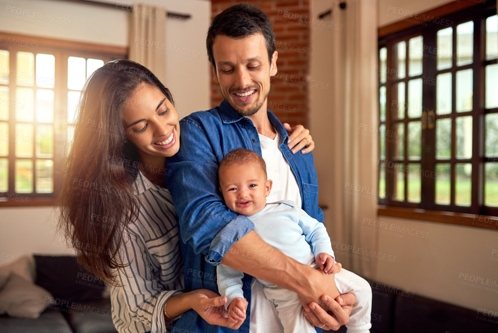 Buy stock photo Cropped shot of an affectionate young couple and their baby boy at home
